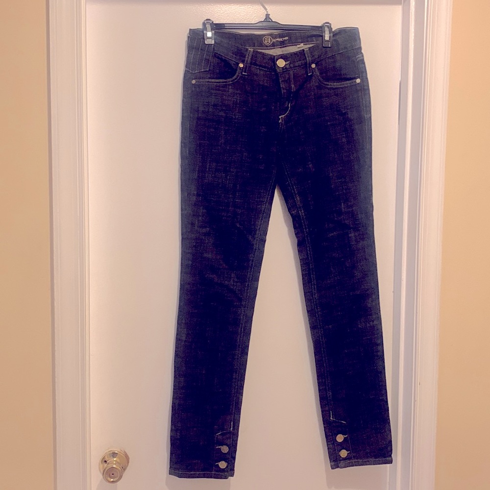 Black denim jeans with gold brass buttons